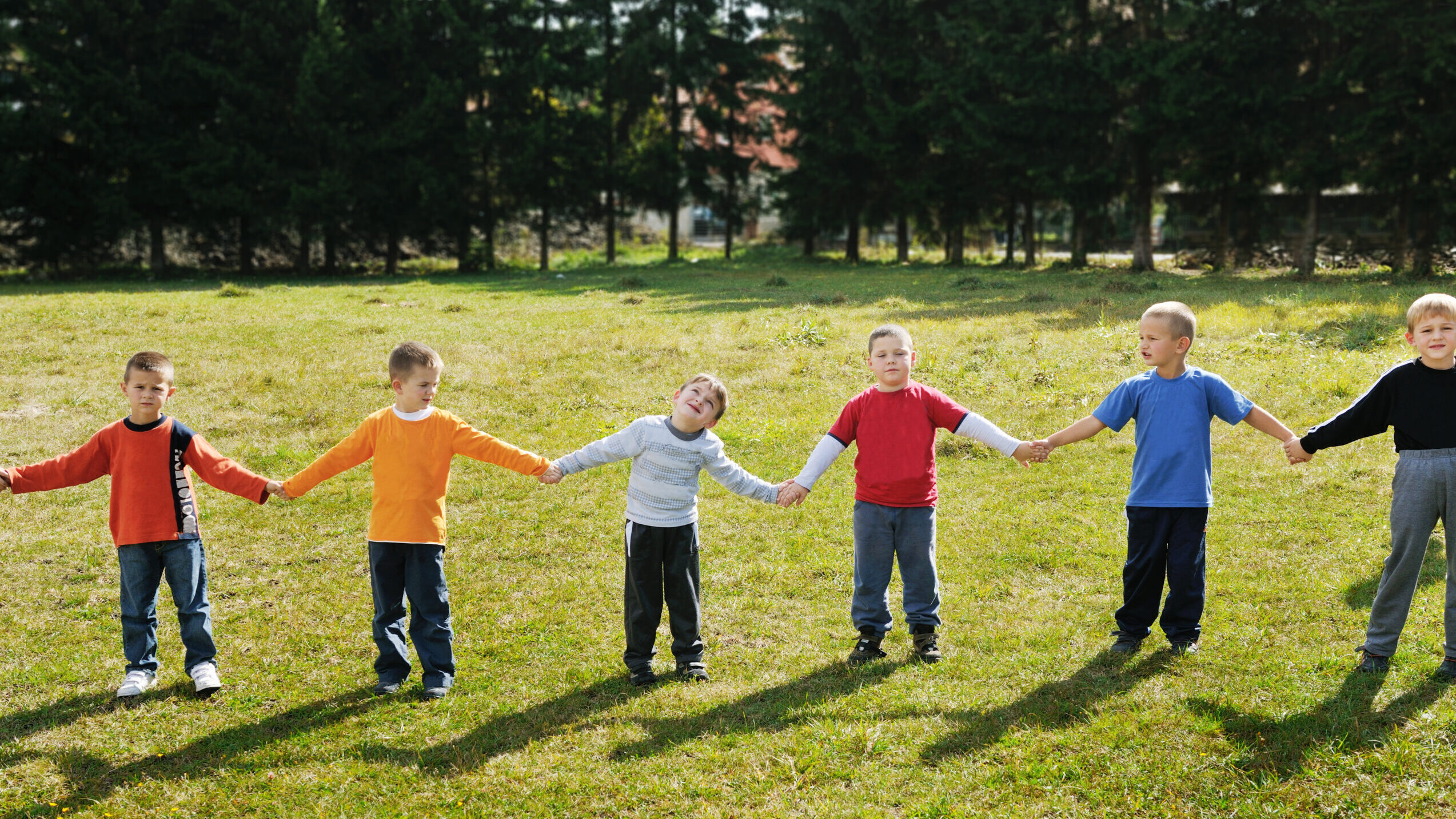 happy child kids group have fun and play at kindergarten outdoor preschool education concept with teacher
